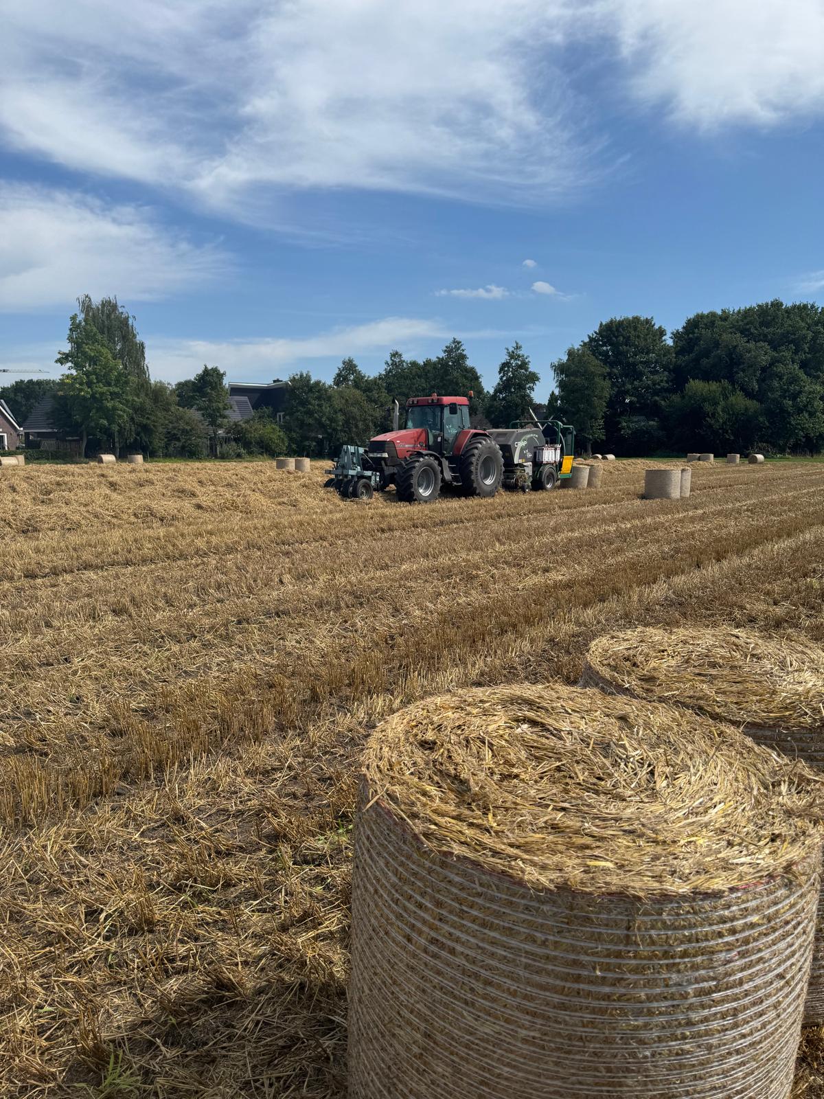 CRIAP perscombinatie aan het werk op een vlak stroperceel met strobalen